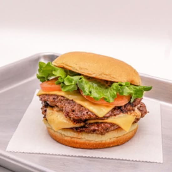 Centro double cheeseburger with two beef patties, cheese, lettuce and tomato on a tray