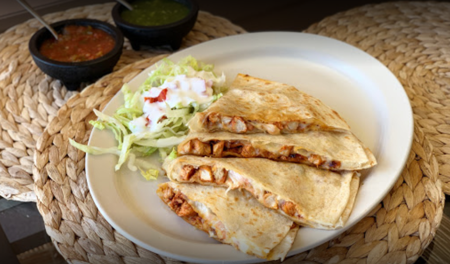 Taqueria Los Sombreros triangle-cut quesadilla with side salad and red and green salsa