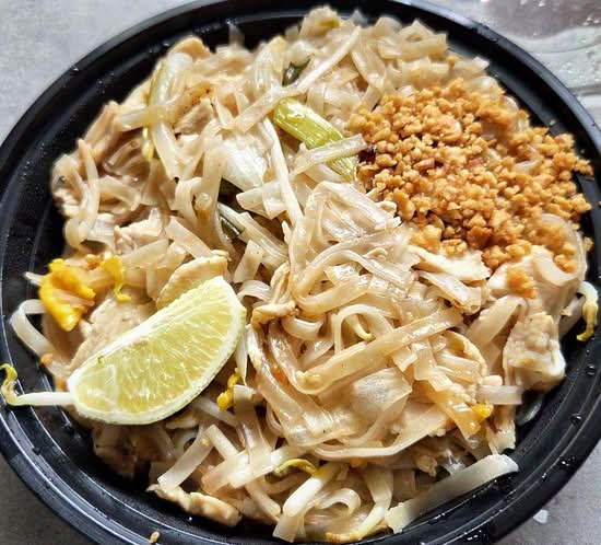 Peak Thai Pad Thai with rice noodles, egg, peanuts and lime in a takeaway bowl