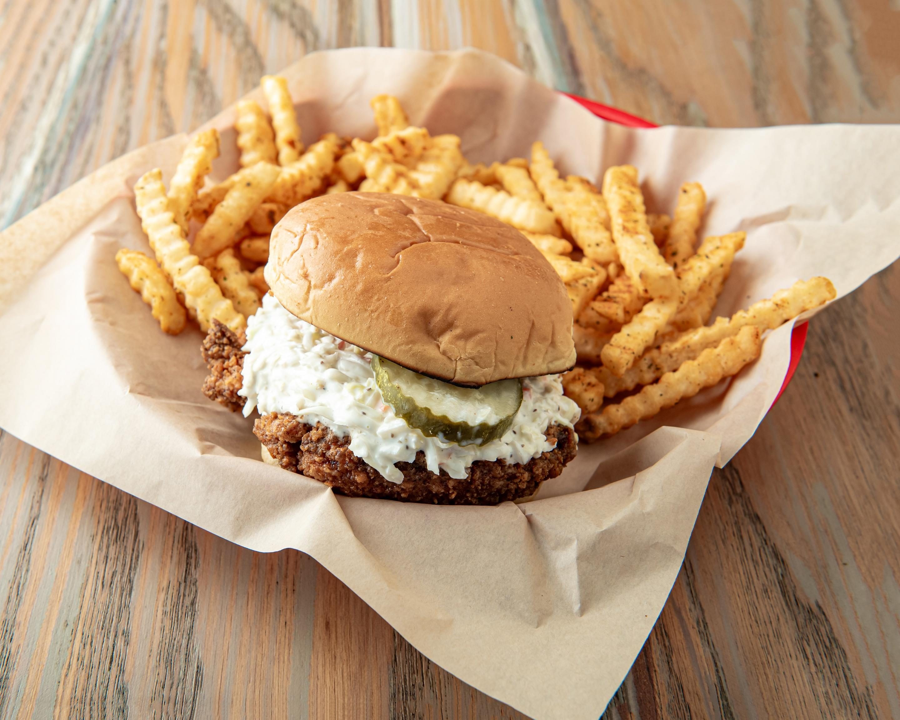 Rude Rooster Nashville Sando chicken sandwich with coleslaw, pickles and crinkle-cut fries; drink not pictured