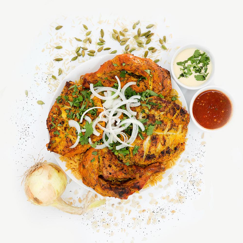 Shawarma Express grilled chicken portions over rice with onion, herbs and two sauce cups