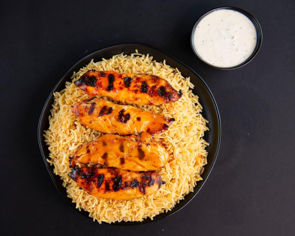 Vasco's flame-grilled chicken over golden rice with a creamy dip